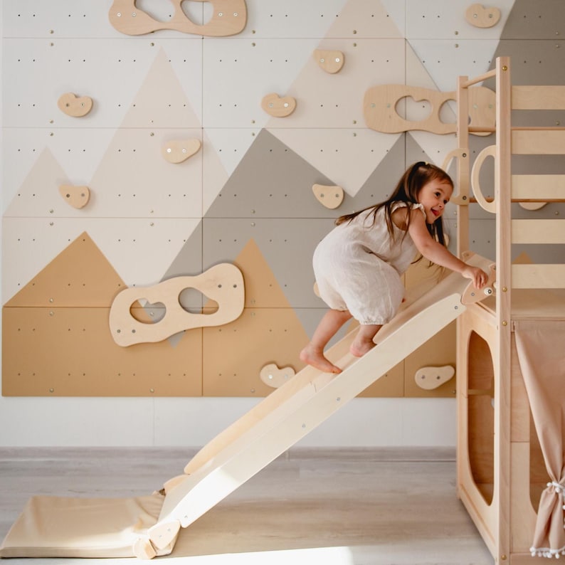 Indoor playhouse feature view with climbing arch and warm Morning Light tones.